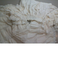 A suit with a full skirt and a white top with puffy sleeves A suit with a full skirt and a white top with puffy sleeves
