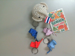 A set of Thai souvenirs: 5 keychains and 1 magnet.