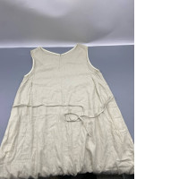 Loose-fitting A-line linen dress in beige.