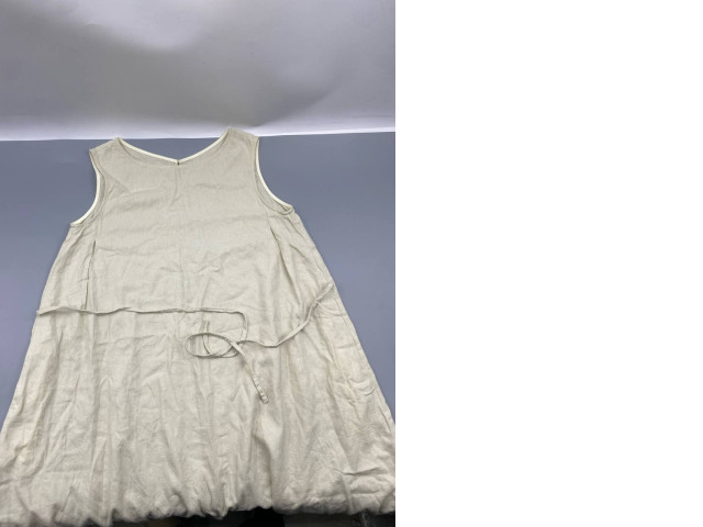 Loose-fitting A-line linen dress in beige. Loose-fitting A-line linen dress in beige.