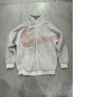 A soft light pink Nike Big Swoosh Reversible Boa jacket with a large Swoosh logo.