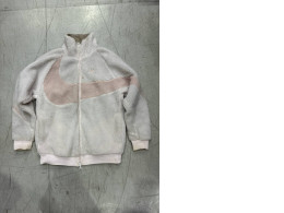 A soft light pink Nike Big Swoosh Reversible Boa jacket with a large Swoosh logo.