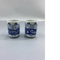 set of 2 A pair of Japanese sumo-themed tea cups.
