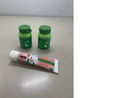 A set of three items: toothpaste and two polishing powders.