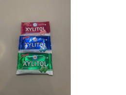 A set of three packs of chewing gum