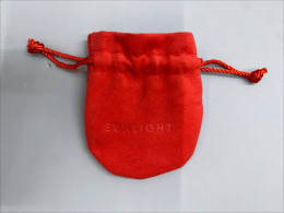 Red felt bag for jewelry.