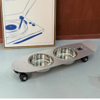 Skateboard-shaped pet food bowl with wheels. Skateboard-shaped pet food bowl with wheels.