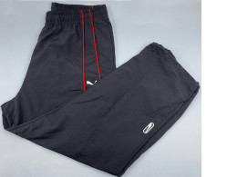 PUMA PUMATECH Relaxed Track Pants in the "Puma Black-For All Time Red" colorway. 