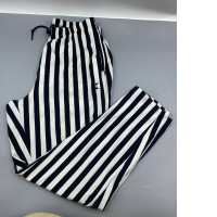 Women's white trousers with black stripes.