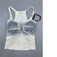 A white racerback tank top from 22 basic studio.