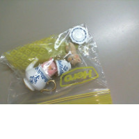 A set of pig figurines drinking tea