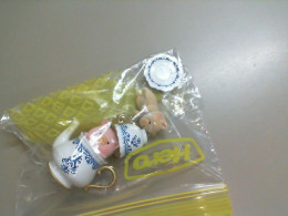 A set of pig figurines drinking tea