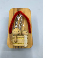 vintage Japanese collectible features two small wooden Kokeshi dolls sitting inside a wooden tub, all mounted on a traditional Geta sandal base. 