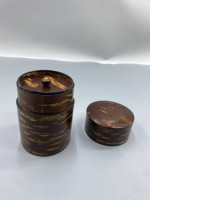 Wooden cylinder for storing tea leaves.