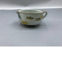 Japanese Kutani porcelain piece, likely from a tea set, featuring crane and pine tree motifs with gold accents. Japanese Kutani porcelain piece, likely from a tea set, featuring crane and pine tree motifs with gold accents.