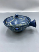 A small, Japanese-style glass baking pot, glazed in blue and decorated with delicate floral or vine patterns.