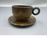 A tea set consisting of a cup and saucer made from coconut wood, often produced by Pvplusproduction.