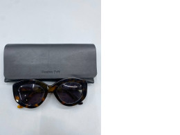 Fashionable women's sunglasses and a black glasses case.