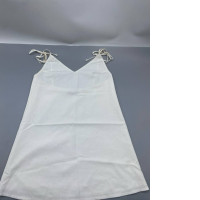 white sleeveless mini dress featuring a sweetheart neckline and adjustable tie straps.