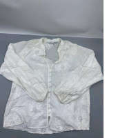 similar floral embroidered shirt designs from Zara, this item is a white long-sleeve blouse featuring eyelet lace and button detailing. 