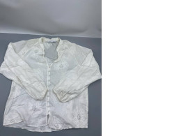 similar floral embroidered shirt designs from Zara, this item is a white long-sleeve blouse featuring eyelet lace and button detailing. 