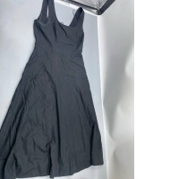 A long, black dress that is fitted and flares out, possibly in the style of Staud Wells.