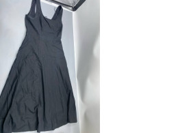 A long, black dress that is fitted and flares out, possibly in the style of Staud Wells.