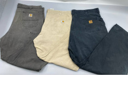 Set of 3 Vintage Carhartt work trousers in moss green, beige, and dark gray.