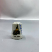 decorative porcelain collectible thimble featuring a travel-themed design of The Grand Palace in Bangkok, Thailand. 