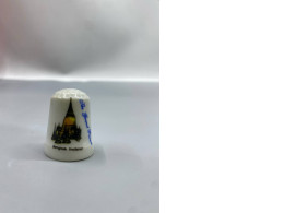 decorative porcelain collectible thimble featuring a travel-themed design of The Grand Palace in Bangkok, Thailand. 