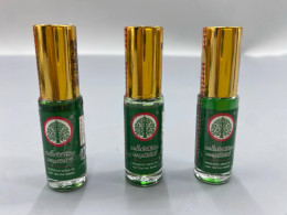 Set of 3 Rup Ton Pho Medicated Green Oil, a Thai herbal product used for relieving muscle pain, bruising, insect bites, and rashes. 