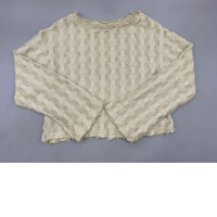 A sheer beige knitted sweater with distressed details, similar to designs from Zara or Comme des Garçons Homme Plus.