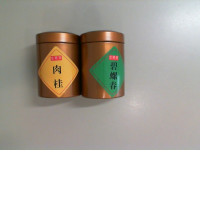 A set of 2 metal jars with Chinese tea