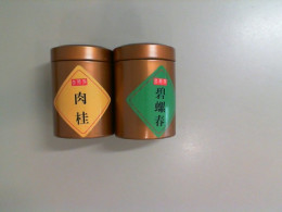 A set of 2 metal jars with Chinese tea