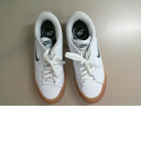 White Adidas sneakers with a green stripe