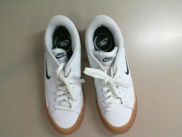 White Adidas sneakers with a green stripe