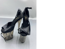 The Pleaser Flamingo-840T high-heeled sandals feature an 8-inch heel and a 4-inch dark-colored front sole.