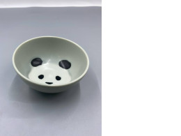 Hasami glass-glazed rice bowl with a black panda design. Hasami glass-glazed rice bowl with a black panda design.