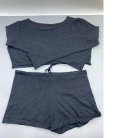 This black knitted pajama set consists of a long-sleeved crop top and matching shorts. This black knitted pajama set consists of a long-sleeved crop top and matching shorts.