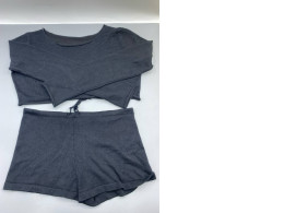 This black knitted pajama set consists of a long-sleeved crop top and matching shorts.