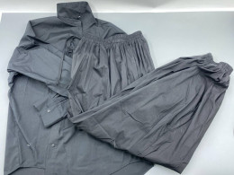 Loose-fitting black parachuting trousers.