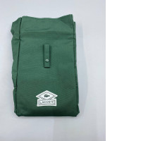 The Lacoste Parfum Garment travel garment bag is made of green canvas.