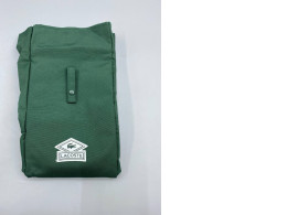 The Lacoste Parfum Garment travel garment bag is made of green canvas.