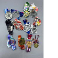 Set of 12 collection of finisher medals from various marathon and running events, primarily located in Thailand and Russia, spanning from 2019 to 2024.
