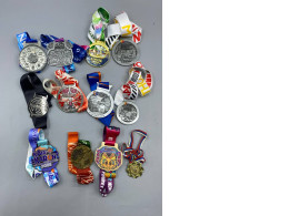 Set of 12 collection of finisher medals from various marathon and running events, primarily located in Thailand and Russia, spanning from 2019 to 2024.