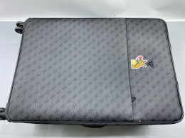 GUESS Wilder wheeled suitcase in dark gray.