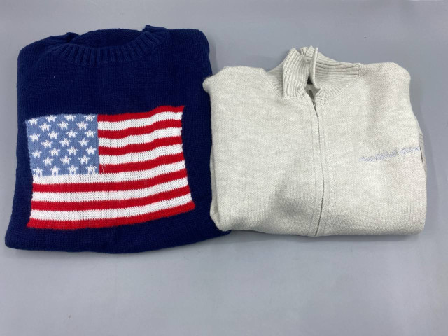 Set of 2 A blue crewneck sweater with an American flag design is on the left, and a light gray zip-up turtleneck sweater is also on the left. Set of 2 A blue crewneck sweater with an American flag design is on the left, and a light gray zip-up turtleneck sweater is also on the left.