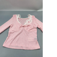 pink long-sleeved top featuring a sweetheart neckline with white lace patchwork detailing. 