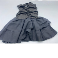 A black women's dress with a halter neck, featuring a pleated bodice and a layered ruffled skirt.