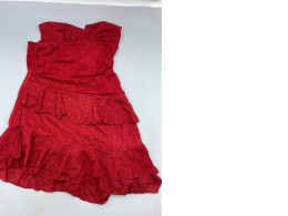 A vintage-style, strapless red cocktail dress with layered ruffle details, reminiscent of styles from the early 2000s.